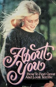 Cover of - About You: How to feel great and look terrific. Portrays a young girl with blond hair, wearing ear rings and a grey seater